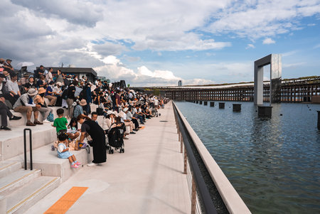Crowd at Waterfront Venue with Elevated Walkway in Osaka, Japan