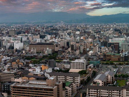 Aerial View of Kyoto Cityscape with Mountains at Sunrise or Sunsetの写真素材