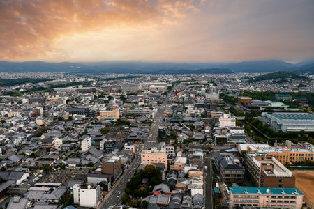 Aerial View of Kyoto Cityscape with Sunset and Surrounding Hillsの写真素材
