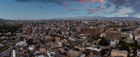 Aerial View of Cityscape with Mountains and Pink Tinged Sky