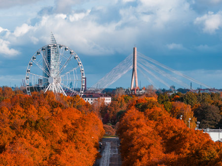 Aerial autumn park corridor toward Vansu Bridge and Ferris wheel, Rigaの写真素材