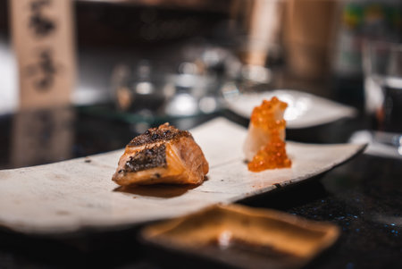 Close up of salmon and ikura course at a refined sushi counter in Japanの写真素材