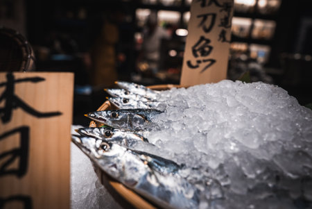 Fresh saury on crushed ice with placards in a Japan marketの写真素材