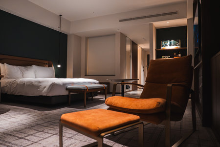 Warmly lit luxury hotel room with Japanese inspired modern designの写真素材