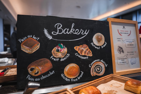 Bakery sign with pastry illustrations in modern hotel dining areaの写真素材