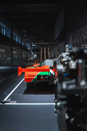 Endurance race car rear view under spotlights in Japanese museum