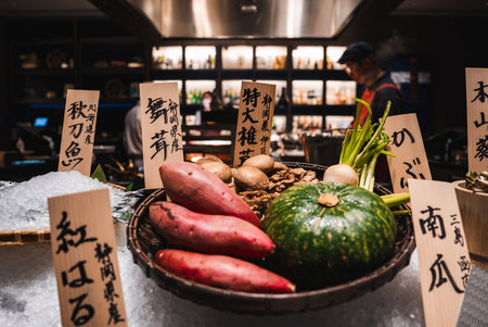 Warm kitchen counter in Japan with seasonal produce and placardsの写真素材
