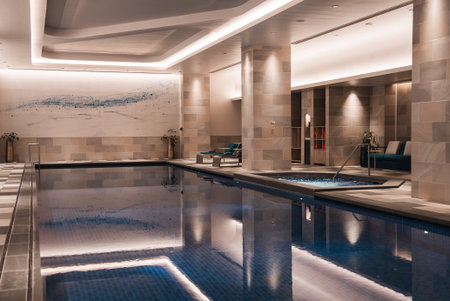 Indoor lap pool with stone pillars and wave mural in Japan hotelの写真素材