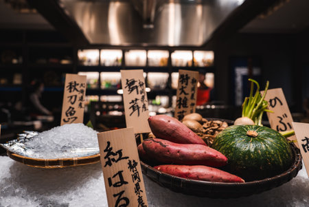 Japanese restaurant display with seasonal produce and placardsの写真素材