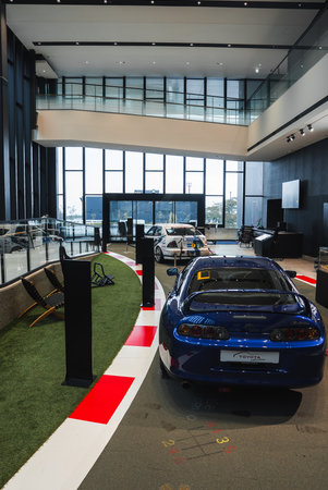 Sports cars on faux racetrack in modern showroom with glass wallsの写真素材