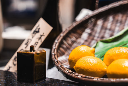Close up of yuzu or lemons and dispenser in Japan settingの写真素材