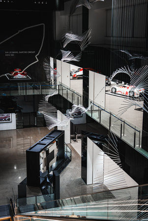 Modern automotive museum interior with race cars and airflow sculptureの写真素材