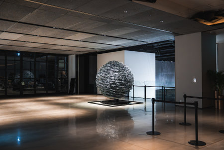 Spherical metal sculpture in minimalist hotel lobby in Japan at night