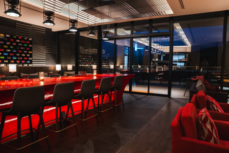 Modern hotel bar with red counter and city skyline at night in Japan