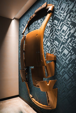 Gold automotive panels form car silhouette on teal wallの写真素材