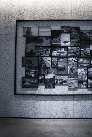Monochrome motorsports photo wall in a modern Japan gallery settingの写真素材