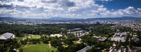 Aerial panorama of Nara Park and city with Todai ji roofs and mountainsの写真素材