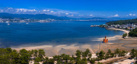 Aerial view of Miyajima Great Torii and Hiroshima shoreline vistasの写真素材