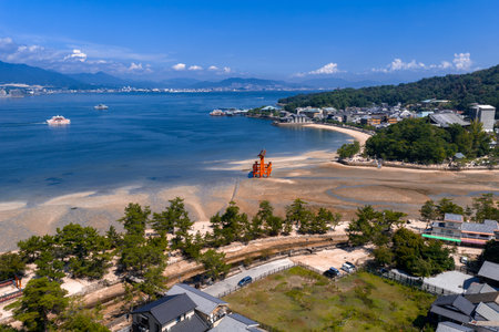 Aerial view of Miyajima with Great Torii and tidal flats at noonの写真素材