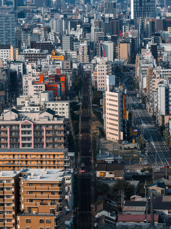 Aerial view of Osaka urban grid with railway corridor and towersの写真素材