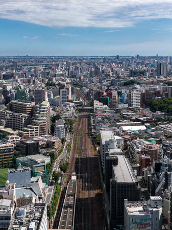 Aerial rail corridor through central Tokyo with Tokyo Tower visibleの写真素材