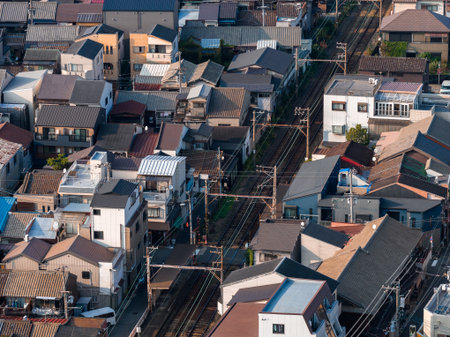 Aerial view of Osaka suburb with rail tracks and compact homesの写真素材