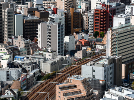 Aerial view of central Tokyo rail lines and dense mid rise towersの写真素材