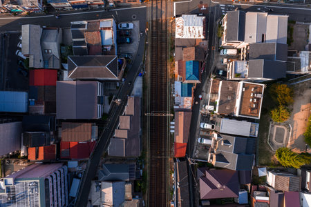 Aerial view of Osaka neighborhood split by commuter rail tracks