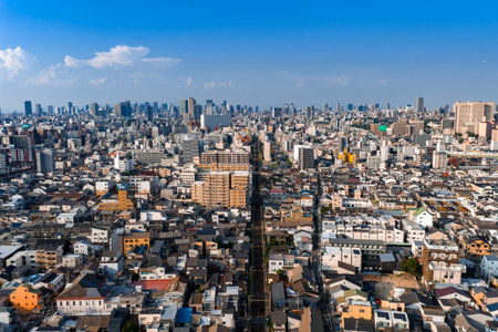 Aerial panorama of Osaka with rail corridor and distant skyscrapers
