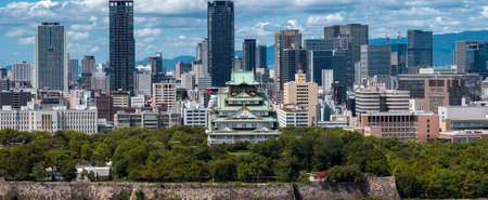 Aerial view of Osaka Castle and downtown skyline in crisp daylightの写真素材