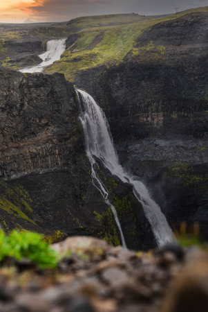 Haifoss and Granni waterfalls descend through basalt canyon, Icelandの写真素材