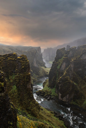 Fjadrargljufur Canyon cliffs and winding river at sunset, Icelandの写真素材