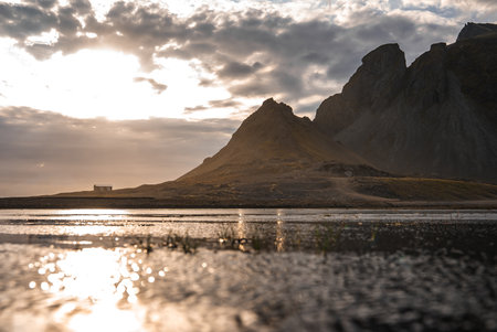 Vestrahorn massif and black sand shoreline at low tide, Icelandの写真素材