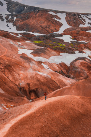 Hiker on rust ridge in Kerlingarfjoll, Iceland Highlands, overcastの写真素材