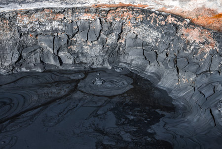 Geothermal mud pool at Hverir near Lake Myvatn in harsh midday lightの写真素材