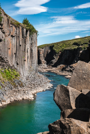 Turquoise river through basalt columns at Studlagil Canyon, Iceland