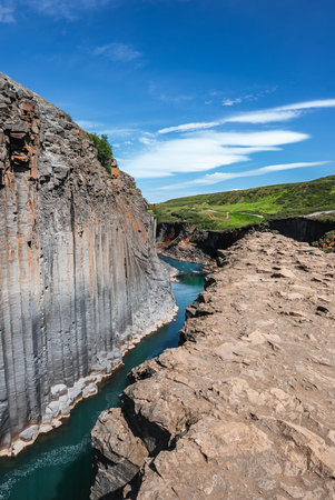 Studlagil Canyon basalt cliffs and turquoise river in East Iceland