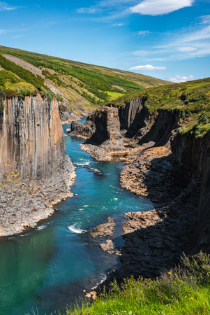 Studlagil Canyon basalt columns and blue river in East Icelandの写真素材