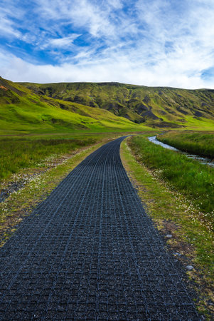 Iceland highland footpath to mossy volcanic hillsの写真素材