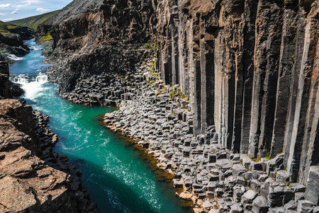 Turquoise river through hexagonal basalt at Stuðlagil Canyon, Icelandの写真素材
