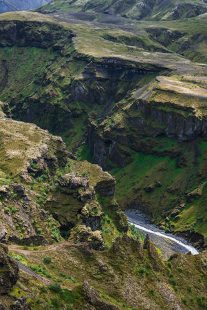 Basalt canyon and river cut through mossy highlands in Icelandの写真素材