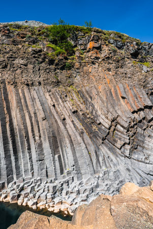 Iceland basalt columns curve along a cliff with summer lightの写真素材
