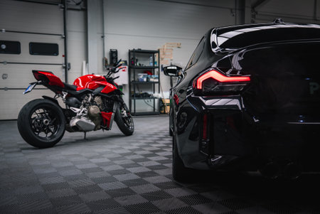 red motorcycle in modern workshop, low rear three quarterの写真素材