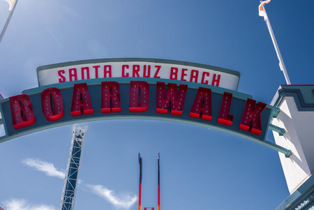 Santa Cruz Beach Boardwalk archway with rides and flags, daytimeの写真素材