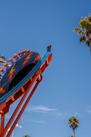 Tilted ride at Santa Cruz Beach Boardwalk under blue daylightの写真素材