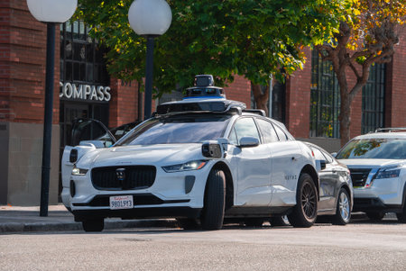 White autonomous SUV by COMPASS storefront in San Franciscoの写真素材