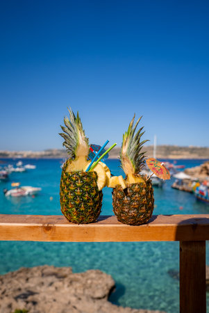 Pineapple cocktails on railing at Blue Lagoon, Comino, Maltaの写真素材