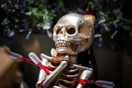 Silver skeleton prop with red droppers threaded through ribcageの写真素材