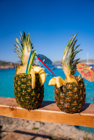 Pineapple cocktails on railing by Comino Island, Malta Blue Lagoonの写真素材