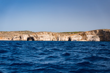 Comino limestone coastline with sea caves and arches in Malta